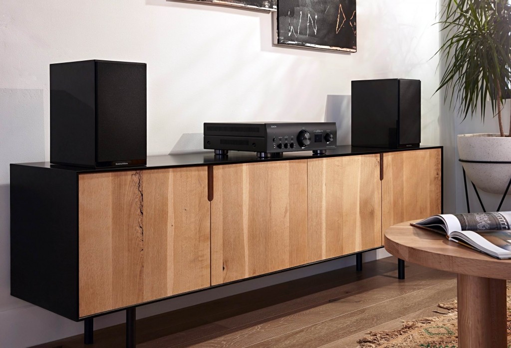 Classic hi-fi control layout with a smooth central volume knob and dedicated tone adjustments