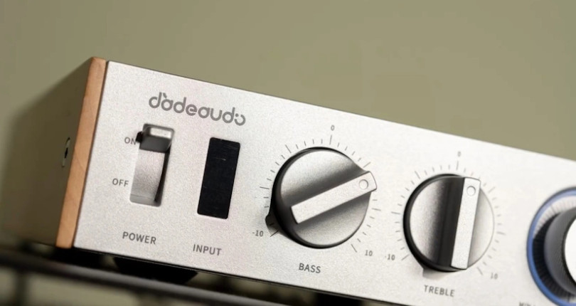 Minimalist front panel with tactile bass and treble controls for quick sound adjustments.