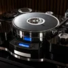 TechDAS unveils the Air Force 20, a massive 100kg high-end turntable featuring air bearings, vacuum hold-down technology, titanium platter options, and flagship-inspired engineering for serious vinyl enthusiasts.