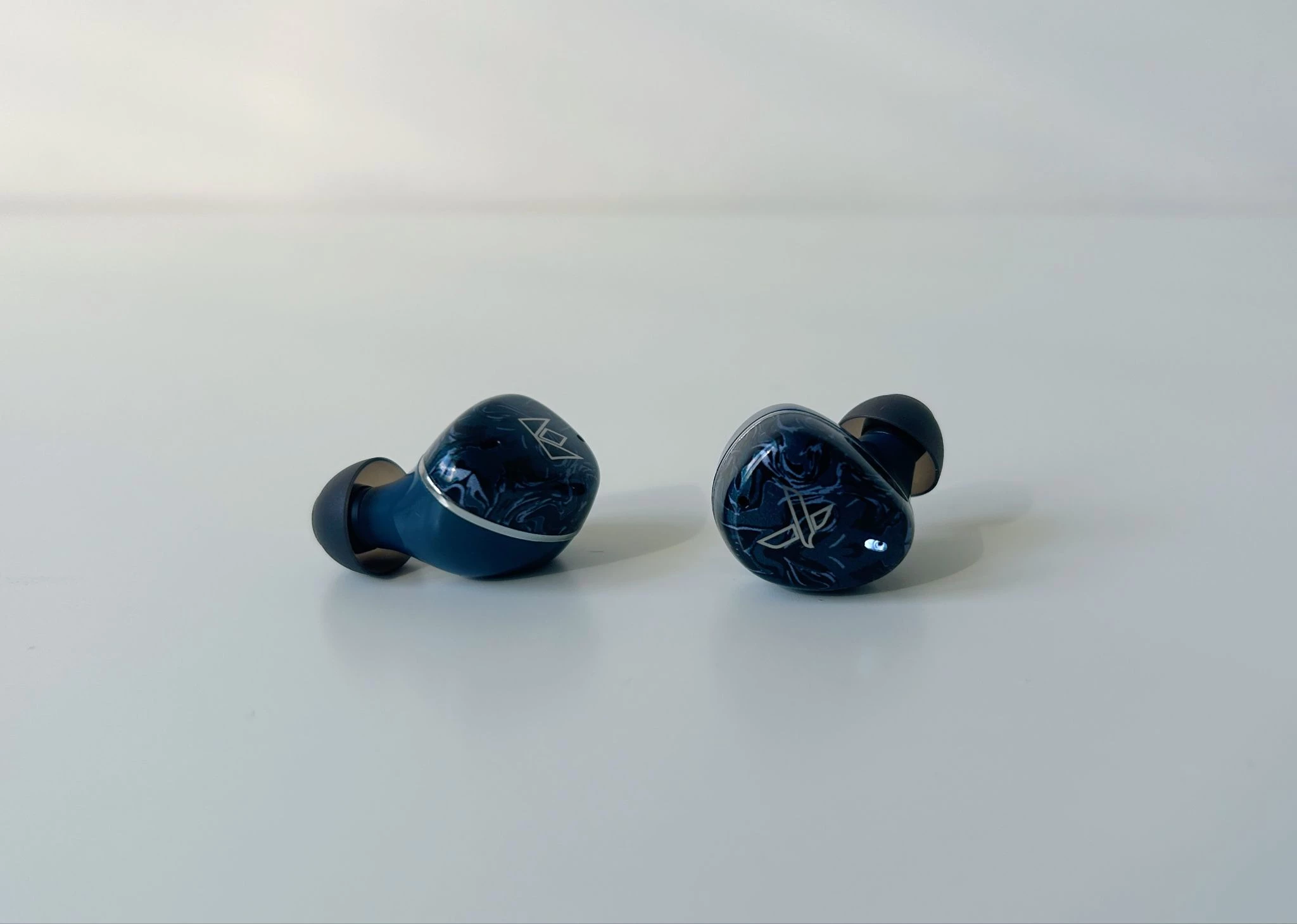 Noble Audio Osprey Review: Boutique Ambition in an Accessible TWS 6 Noble Audio Osprey blue true wireless earbuds with patterned acrylic faceplates and charging case