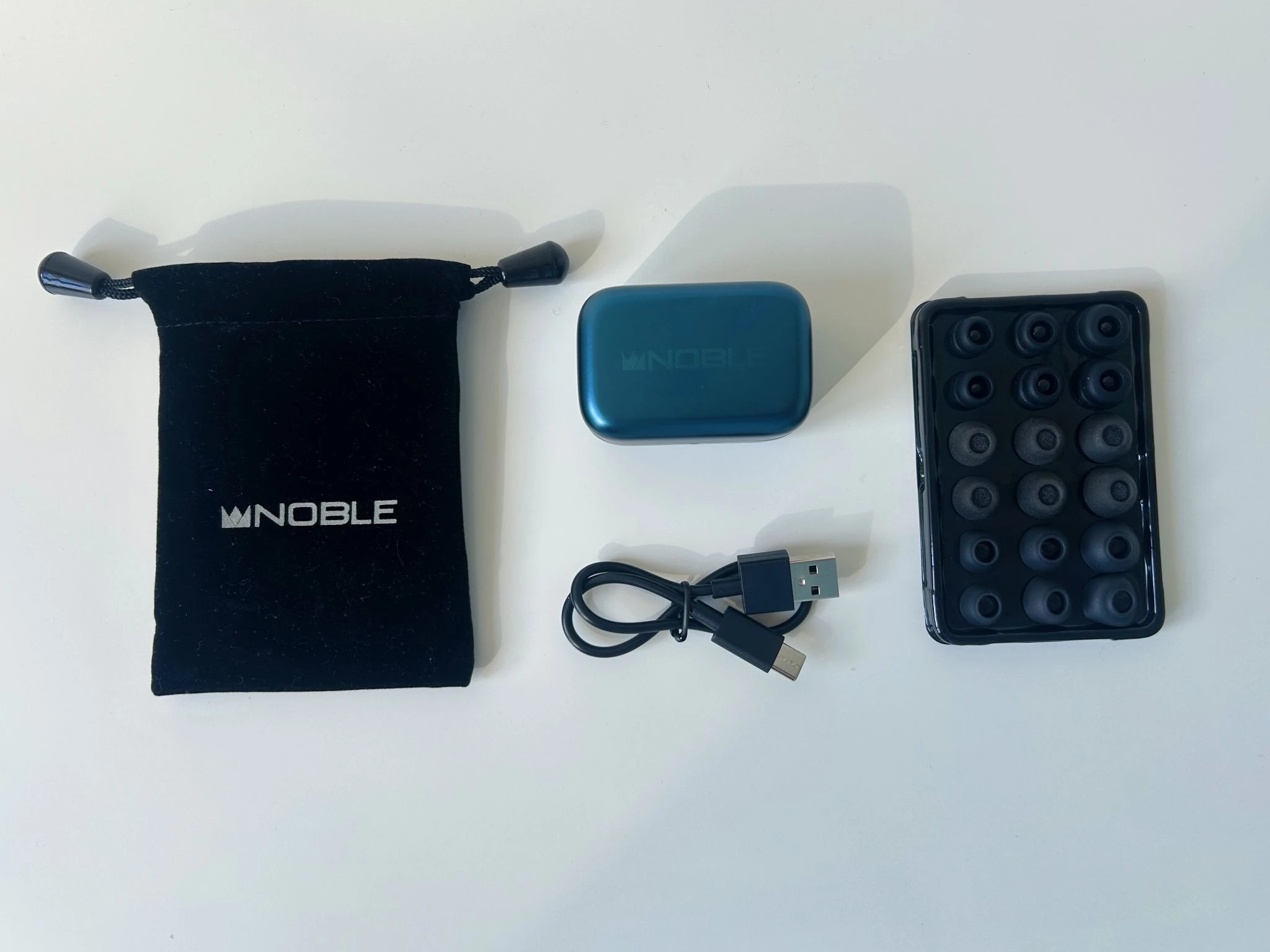 Noble Audio Osprey Review: Boutique Ambition in an Accessible TWS 5 Noble Audio Osprey blue true wireless earbuds with patterned acrylic faceplates and charging case