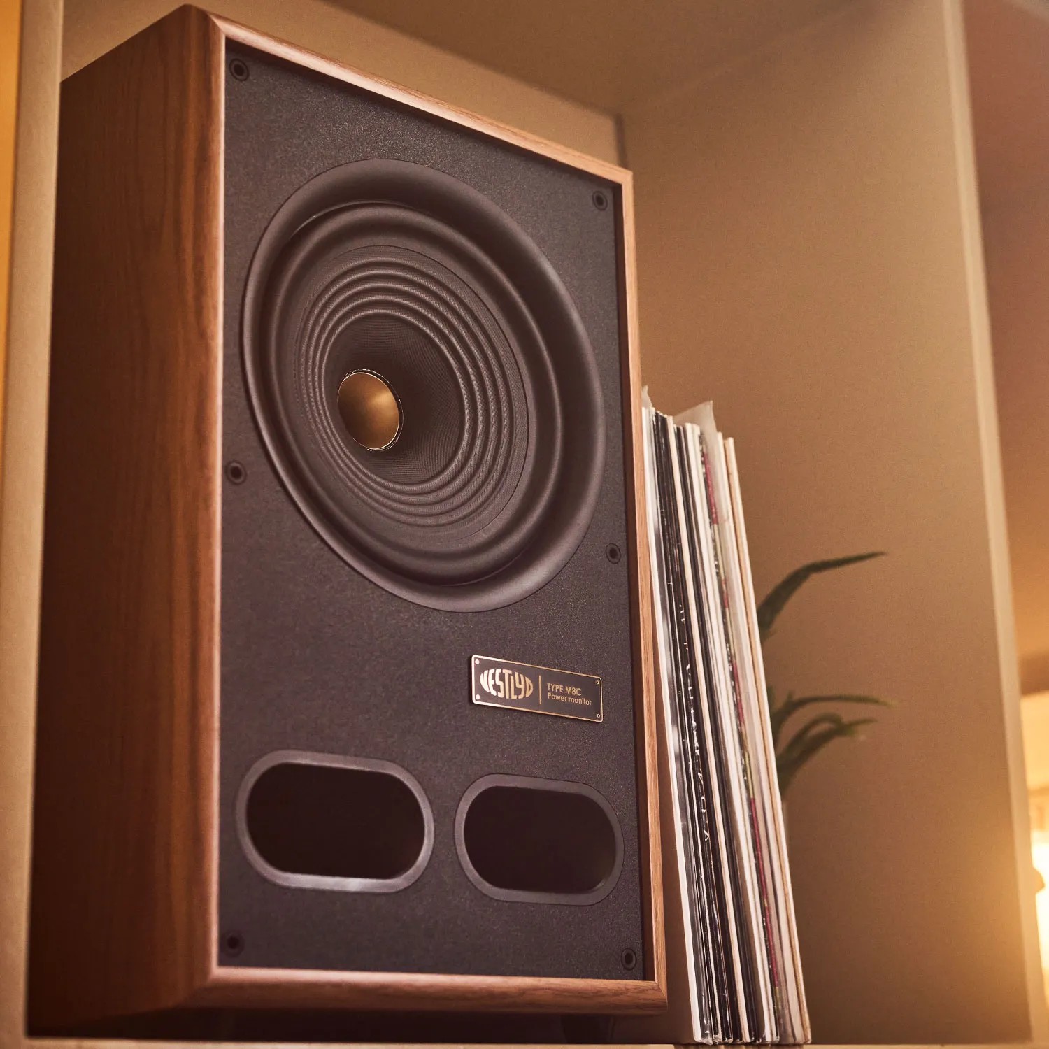 Vestlyd M8C Active Recasts the Power Monitor as a Complete Audio Hub 23 The exposed front shows the M8C’s 8-inch coaxial arrangement, gold-colored center and two rounded rectangular ports, while the angled cabinet displays its substantial depth.