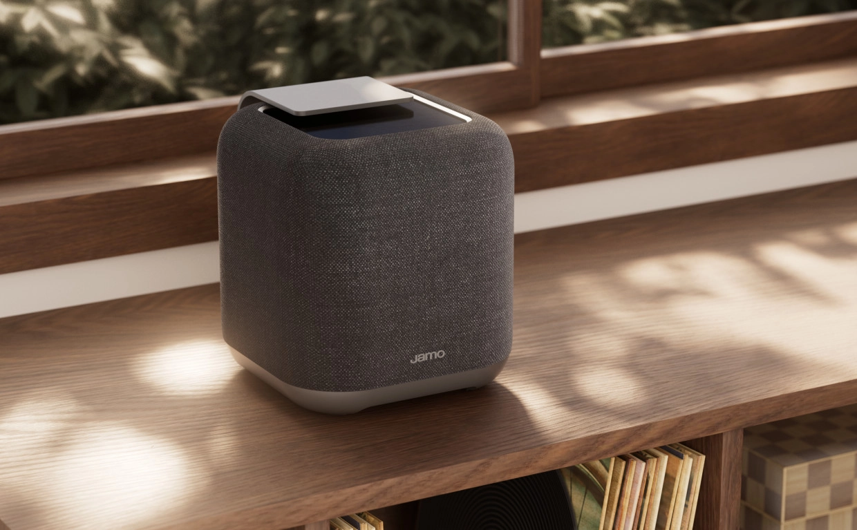 Jamo Hyg 5 Makes the Wireless Speaker Part of the Room 23 Grey fabric Jamo speaker on a wooden cabinet beside sunlit windows
