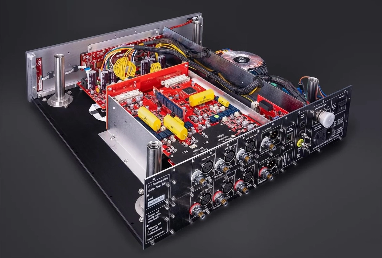 Inside CH Precision’s P1.5 and L1.5 Preamp Redesigns 25 Rear interior of P1.5 showing multiple XLR and RCA connections, red boards, capacitors and toroidal transformer